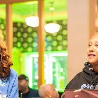 Two women at event sitting at table